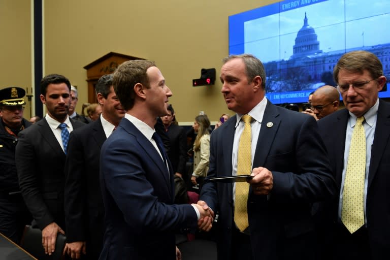 Facebook CEO and founder Mark Zuckerberg (L) receives a copy of the US Constitution from Rep. Jeff Duncan after a hearing on social media