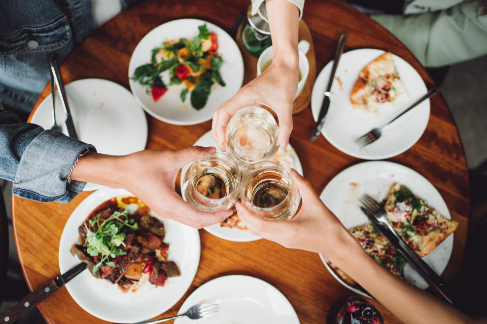 Top view of a group of friends having a celebrate toss over lunch gathering.