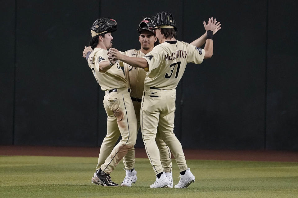 From left to right, Arizona Diamondbacks outfielders Corbin Carroll, Alek Thomas and Jake McCarthy celebrate after their win over the Chicago Cubs in the ninth inning of a baseball game Sunday, Sept. 17, 2023, in Phoenix. (AP Photo/Darryl Webb)