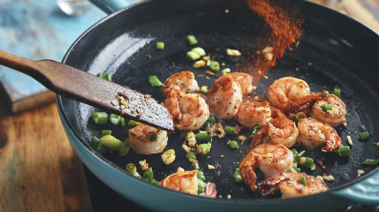 cooking shrimp in pan on stove