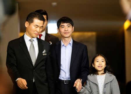 The world’s top Go player Lee Sedol walks with his daughter Lee Hye-lim as he heads for the venue of the last match of the Google DeepMind Challenge Match against Google's artificial intelligence program AlphaGo in Seoul, South Korea, March 15, 2016. REUTERS/Kim Hong-Ji