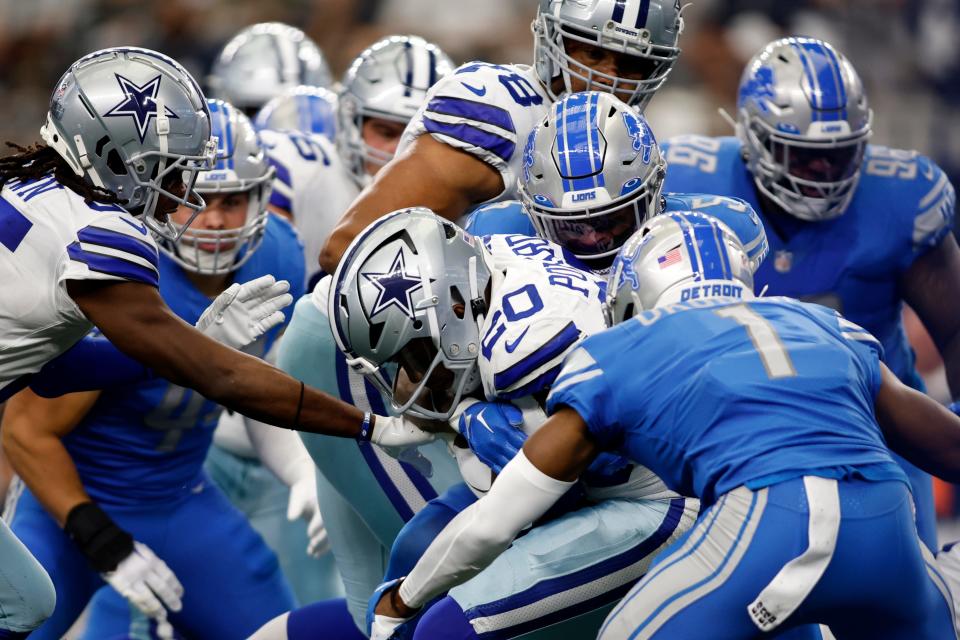 Dallas Cowboys running back Tony Pollard is tackled by the Detroit Lions defense at AT&T Stadium, Oct. 23, 2022 in Arlington, Texas.