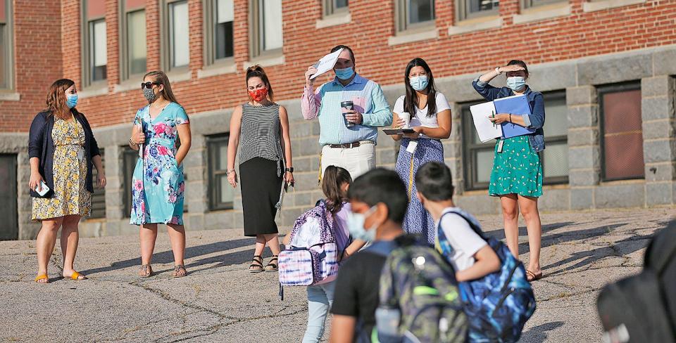 Teachers wait for students to arrive on the first day of classes at Point Webster Middle School in Quincy on Wednesday, Sept. 8, 2021.