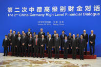 German Finance Minister Olaf Scholz and Chinese Vice Premier Liu He and both countries' delegates pose for a group photo before the China-Germany High Level Financial Dialogue at the Diaoyutai State Guesthouse in Beijing, Friday, Jan. 18, 2019. (AP Photo/Andy Wong, Pool)