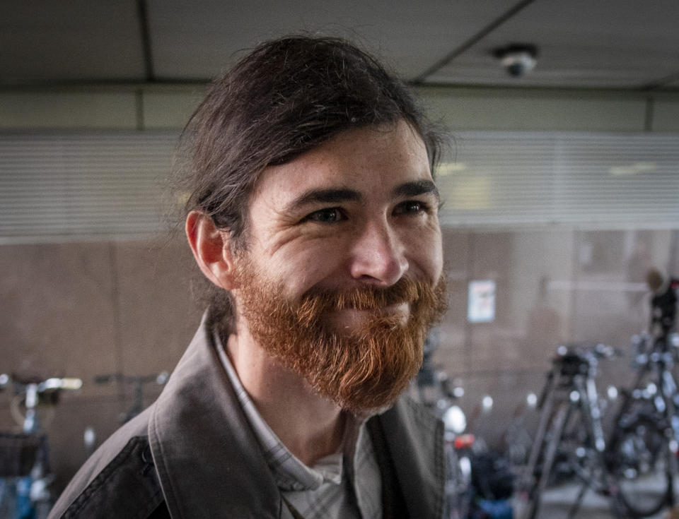 The defendant identified only as 1st Lt. Franco A. due to German privacy rules, walks to a court for the start of a trial on charges of preparing a serious act of violence endangering the state in Frankfurt, Germany, Thursday, May 20, 2021. The 32-year-old is alleged to have procured weapons for an alleged right-wing extremist motivation in order to carry out attacks. According to the indictment, he posed as a Syrian in order to draw suspicion to refugees. (AP Photo/Michael Probst)