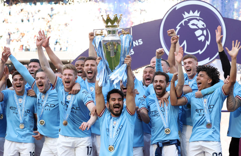 Manchester City players celebrate winning the English Premier League.