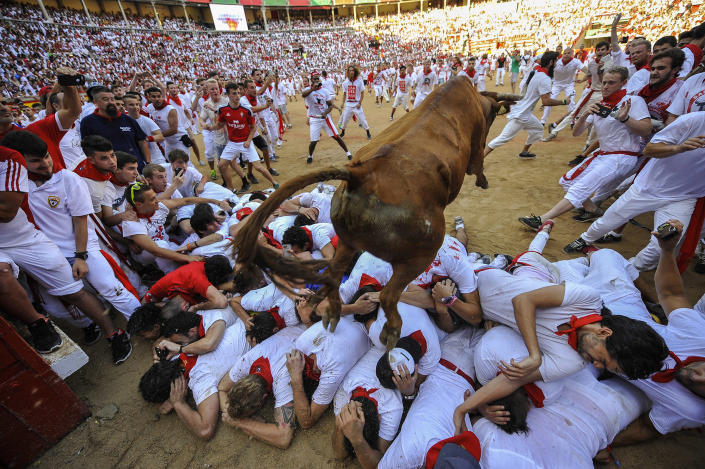 <p>A cow jumps over revelers during cow’s festival at the end second running of the bulls at the San Fermin Festival, in Pamplona, norther Spain, Friday, July 8, 2016. (Photo: Alvaro Barrientos/AP) </p>