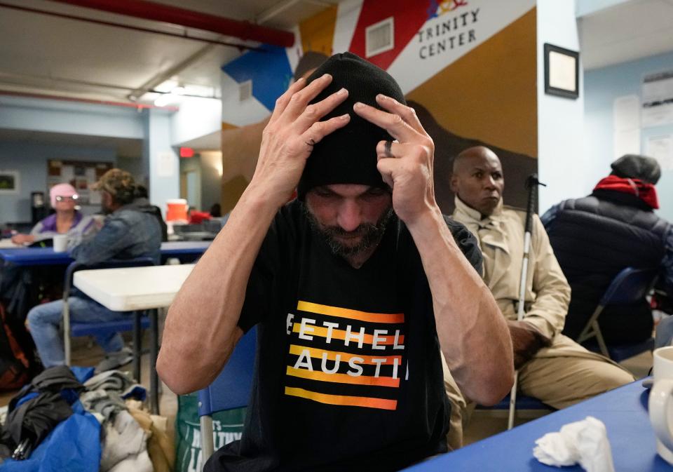 Edward Hebert, who is homeless, puts on his knit cap at the Trinity Center. The capacity of 300 at the city's shelters is thousands below the estimated homeless population in the area.