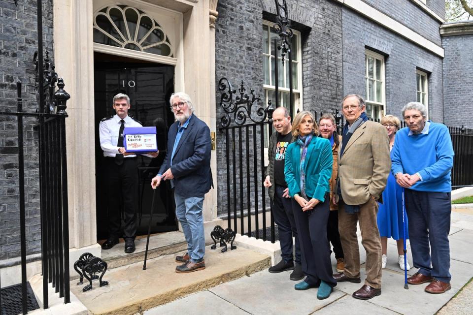 Jeremy Paxman with the co-hosts of the Movers and Shakers podcast deliver a petition to Downing Street on Thursday April 11 (Matt Crossick Media Assignments/PA Wire)