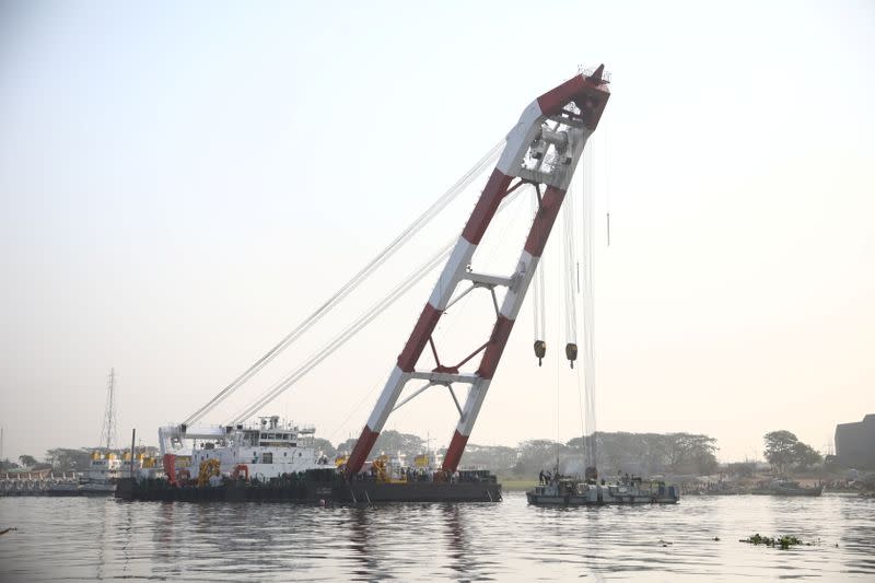 A rescue ship is seen at the site where several people died after a ferry collided with a cargo vessel and sank on Sunday in the Shitalakhsyaa River in Narayanganj