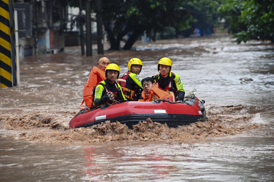 In this photo released by Xinhua News Agency, rescuers evacuate flood trapped residents following a flood in Wanzhou District, in southwest China's Chongqing Municipality, Tuesday, July 4, 2023. Heavy flooding has displaced thousands of people around China as the capital had a relative respite from sweltering heat. (Ran Mengjun/Xinhua via AP)