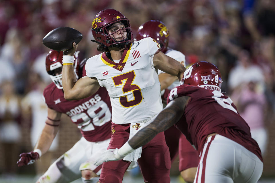 Iowa State quarterback Rocco Becht (3) throws a pass under pressure from Oklahoma defensive lineman Jonah Laulu (8) during the first half of an NCAA college football game Saturday, Sept. 30, 2023, in Norman, Okla. (AP Photo/Alonzo Adams)