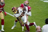 Washington Football Team wide receiver Cam Sims (89) is hit by San Francisco 49ers free safety Jimmie Ward (20) during the first half of an NFL football game, Sunday, Dec. 13, 2020, in Glendale, Ariz. (AP Photo/Ross D. Franklin)