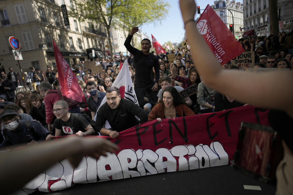 FILE - Demonstrators hold a banner that reads: "Against Le Pen", during a protest against the far-right in Paris, April 16, 2022. Disgruntled left-wing voters whose candidates were knocked out in the first round of France's election are the wild cards in the winner-takes-all runoff on Sunday April 24, 2022. How they vote — or don’t vote — will in large part determine whether incumbent Emmanuel Macron gets a second five-year term or cedes the presidential Elysee Palace to far-right nationalist Marine Le Pen. (AP Photo/Christophe Ena, File)