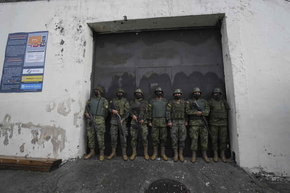 Soldiers guard an entrance to the Inca jail where eight inmates were killed during a prison riot, according to Police Commander Victor Herrera, in Quito, Ecuador, Friday, Nov. 18, 2022. (AP Photo/Dolores Ochoa)