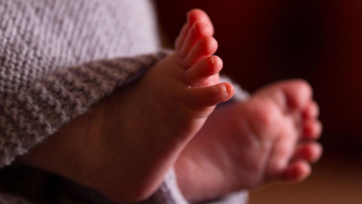 Baby's feet poking out from a blanket