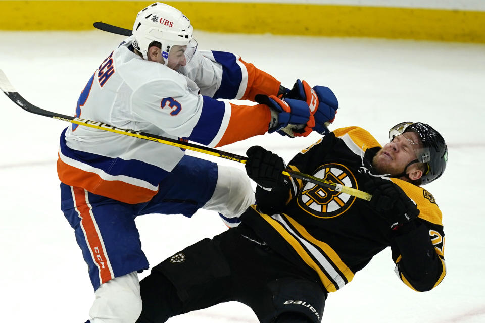 New York Islanders defenseman Adam Pelech (3) checks Boston Bruins right wing Ondrej Kase (28) to the ice in the second period of an NHL hockey game, Monday, May 10, 2021, in Boston. (AP Photo/Elise Amendola)