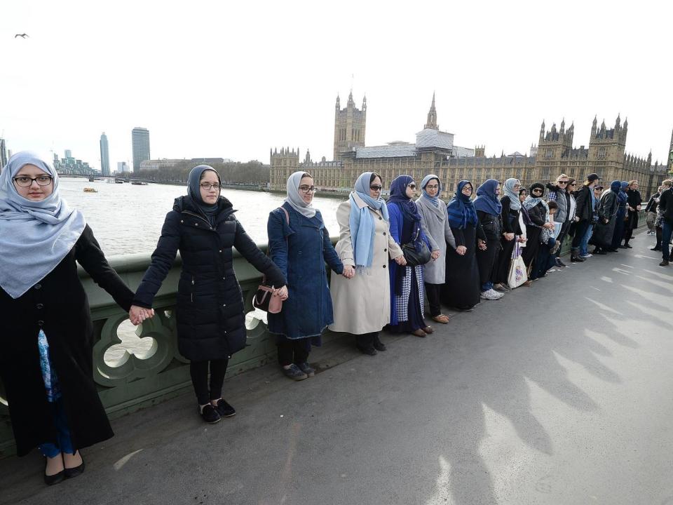 The women, some of whom said they were wearing blue as a symbol of hope, held hands for five minutes (PA)