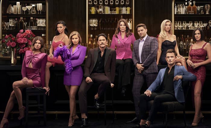 The cast of Vanderpump Rules Season 10 in front of a bar