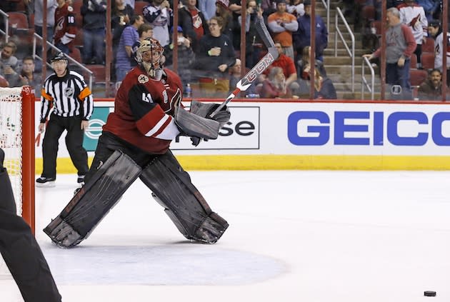 Arizona Coyotes goalie Mike Smith picks up his stick after giving up the game-winning goal to Columbus Blue Jackets center Sam Gagner during the shootout of an NHL hockey game Saturday, Dec. 3, 2016, in Glendale, Ariz. The Blue Jackets defeated the Coyotes 3-2 in a shootout. (AP Photo/Ross D. Franklin)