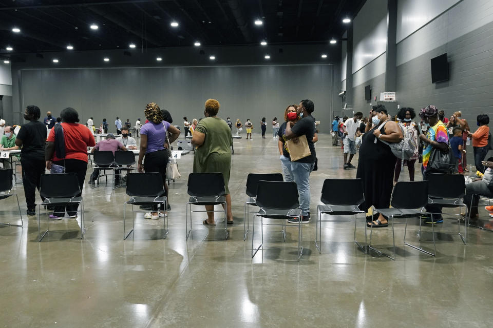 FILE—Applicants at a rental assistance fair for Jackson residents at the Mississippi Trademart, line up to be assigned the proper station in the state Fairgrounds, Saturday, July 24, 2021, in Jackson, Miss. States have begun to ramp up the amount of rental assistance reaching tenants but there are still millions of families facing eviction who haven't gotten help. The Treasury Department says just $5.1 billion of the estimated $46.5 billion in federal rental assistance, or only 11%, has been distributed by states and localities through July. (AP Photo/Rogelio V. Solis, File)