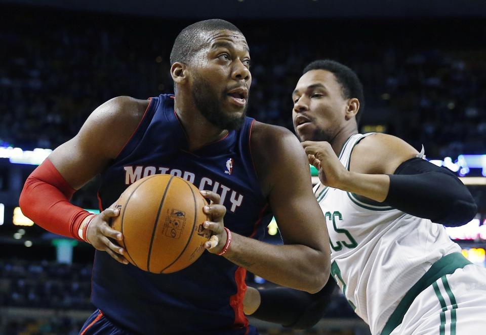 Detroit Pistons' Greg Monroe, left, looks to shoot past Boston Celtics' Jared Sullinger, right, in the first quarter of an NBA basketball game in Boston, Sunday, March 9, 2014. (AP Photo/Michael Dwyer)