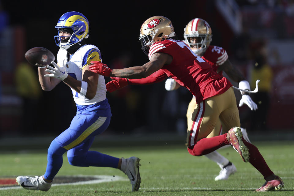 Los Angeles Rams wide receiver Puka Nacua, left, catches a pass in front of San Francisco 49ers cornerback Charvarius Ward during the first half of an NFL football game in Santa Clara, Calif., Sunday, Jan. 7, 2024. (AP Photo/Jed Jacobsohn)