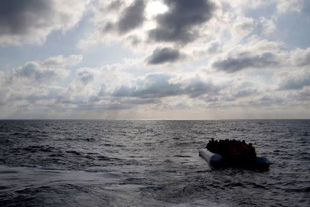 Migrants in a dinghy await rescue by the Migrant Offshore Aid Station (MOAS), around 20 nautical miles off the coast of Libya, June 23, 2016. REUTERS/Darrin Zammit Lupi
