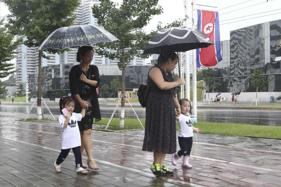 Residents walk along Changjon Street during the 77th anniversary of Korea's Liberation in Pyongyang, North Korea, Monday, Aug. 15, 2022. (AP Photo/Jon Chol Jin)