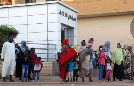 Residents stand outside an automated teller machine (ATM) in Khartoum, Sudan November 8, 2018. Picture taken November 8, 2018. REUTERS/Mohamed Nureldin Abdallah
