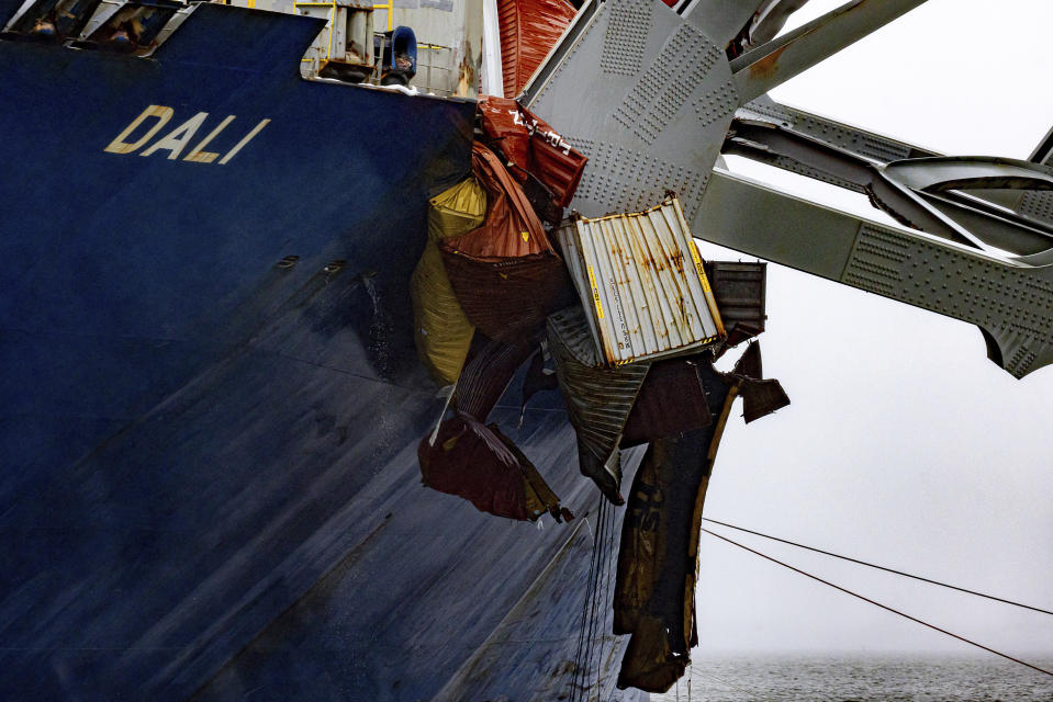 Containers are crushed as wreckage of the Francis Scott Key Bridge rests on the container ship Dali, Wednesday, April 3, 2024, in Baltimore. (AP Photo/Julia Nikhinson)