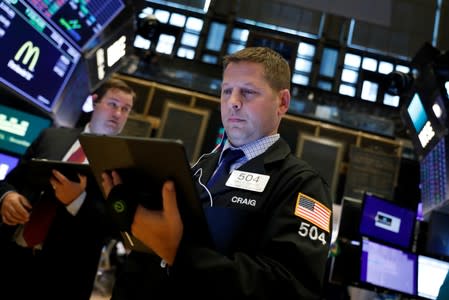 Traders work on the floor at the NYSE in New York