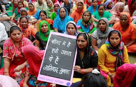 Family members of sanitation workers attend a protest against the rising deaths of people cleaning sewers, in New Delhi, India, September 25, 2018. REUTERS/Adnan Abidi