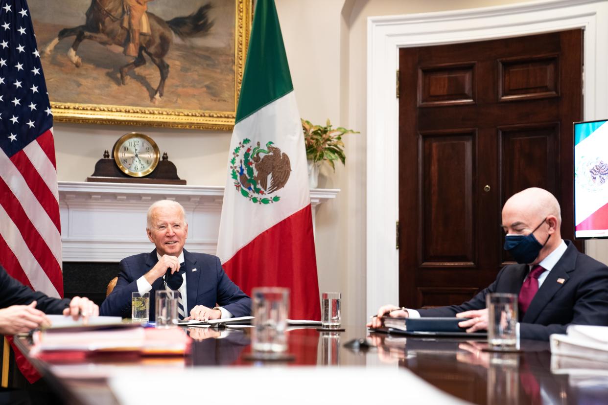 Joe Biden, left, and Homeland Security Secretary Alejandro Mayorkas attending a virtual meeting with their Mexican counterparts on Monday. (Getty Images)