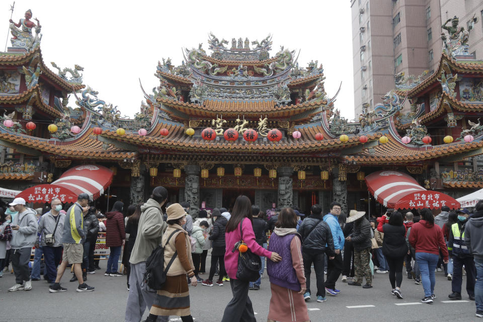 Worshippers go to pray at a temple on the first day of the Lunar New Year celebrations, in Taipei, Taiwan, Saturday, Feb. 10, 2024. Each year is named after one of the 12 signs of the Chinese zodiac in a repeating cycle, with this year being the Year of the Dragon. (AP Photo/Chiang Ying-ying)