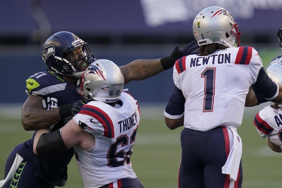 FILE - In this Sunday, Sept. 20, 2020, file photo, Seattle Seahawks linebacker Bruce Irvin, letft, is blocked by New England Patriots offensive guard Joe Thuney as he pressures quarterback Cam Newton (1) during the first half of an NFL football game, in Seattle. A big part of the success the Patriots have enjoyed on offense this season has to do with the discipline of its offensive line. (AP Photo/Elaine Thompson, File)