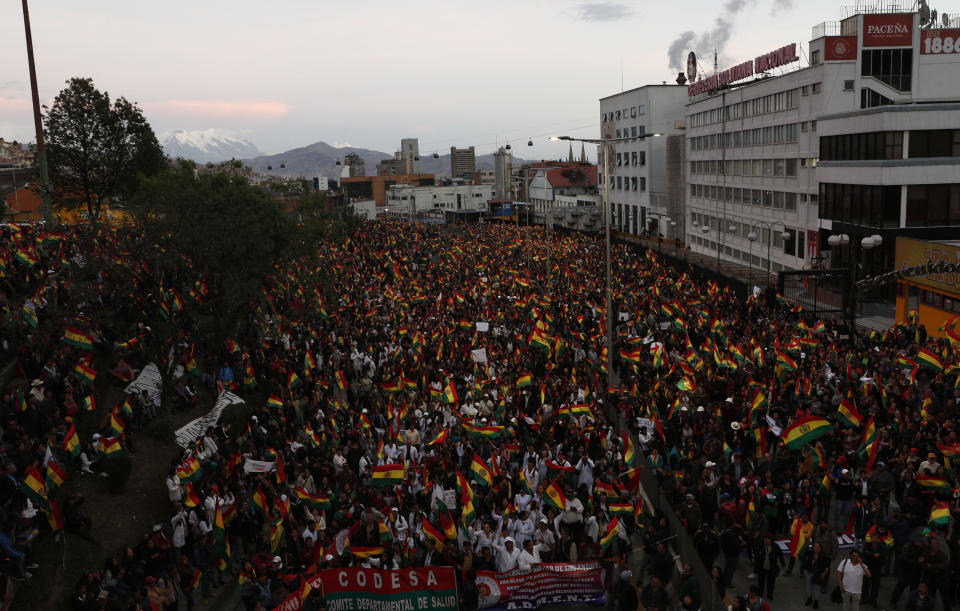 Anti-government protesters gather against the reelection of President Evo Morales, in La Paz, Bolivia, Thursday, Oct. 31, 2019. Violence has escalated since Morales was declared the winner of the Oct. 20 vote amid delays in the vote count. The opposition alleges the outcome was rigged to give Morales enough of a majority to avoid a runoff election; the president denies any irregularities. (AP Photo/Juan Karita)