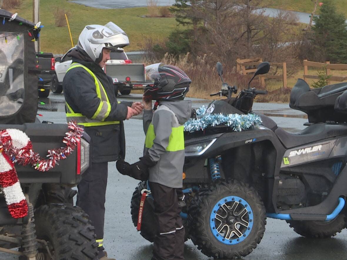 Helmets likes the one being worn by these riders at a recent charity event on the Avalon Peninsula are now mandatory for all off-road vehicles in Newfoundland and Labrador. The new helmet and seatbelt law came into force in May. (Henrike Wilhelm/CBC - image credit)