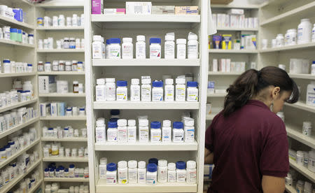 FILE PHOTO: A pharmacy employee looks for medication as she works to fill a prescription while working at a pharmacy in New York December 23, 2009. REUTERS/Lucas Jackson (UNITED STATES