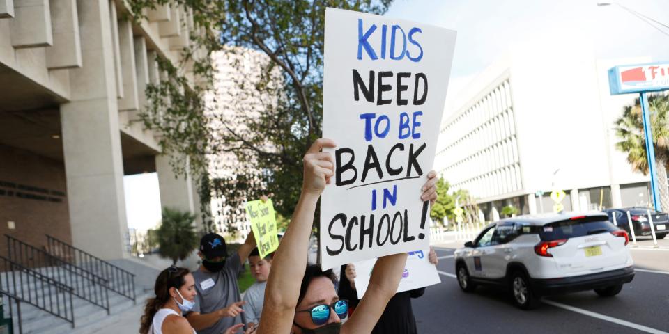 TAMPA, FL - AUGUST 06: Bright Owens a supporter calling for Hillsborough County schools to reopen protests ahead of a meeting of the school board at the Hillsborough County Public Schools district office on August 6, 2020 in Tampa, Florida. The Hillsborough County School Board held a special meeting to decide if schools will reopen during the COVID-19 pandemic. (Photo by Octavio Jones/Getty Images)