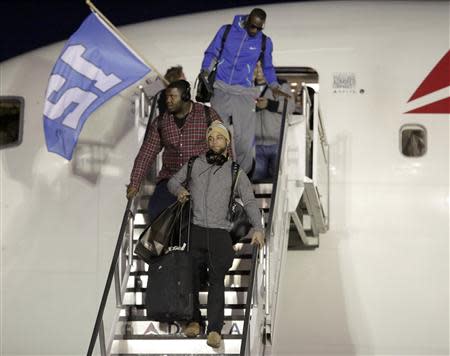 Seattle Seahawks' Golden Tate (bottom) exits the team's chartered plane as the Seahawks return home after winning NFL Super Bowl XLVIII at Sea-Tac Airport in Seattle, Washington February 3, 2014. REUTERS/Jason Redmond