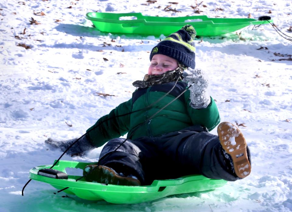 Eli Seay, 4, slides down hill at Barfield Park aw he endures the cold to play in the show on Tuesday, Jan. 16, 2024.