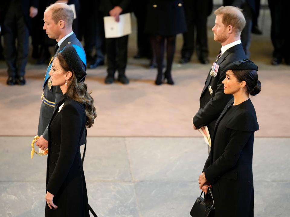 Prince Willia, Kate Middleton, Prince Harry, and Meghan Markle pay their respects in The Palace of Westminster after the procession for the Lying-in State of Queen Elizabeth II on September 14, 2022 in London, England.