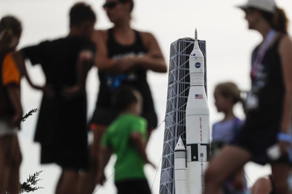 Visitors gather on the grounds of the Armstrong Air and Space Museum as a scale model of NASA's developing Space Launch System is displayed as part of events commemorating the 50th anniversary of the first moon landing, Saturday, July 20, 2019, in Wapakoneta, Ohio. (AP Photo/John Minchillo)