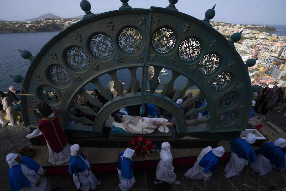 People carry a "Mistero", a float depicting a biblical scene during a procession in Procida Island, Italy, Friday, March 29, 2024. Italy is known for the religious processions that take over towns big and small when Catholic feast days are celebrated throughout the year. But even in a country where public displays of popular piety are a centuries-old tradition, Procida's Holy Week commemorations stand out. (AP Photo/Alessandra Tarantino)