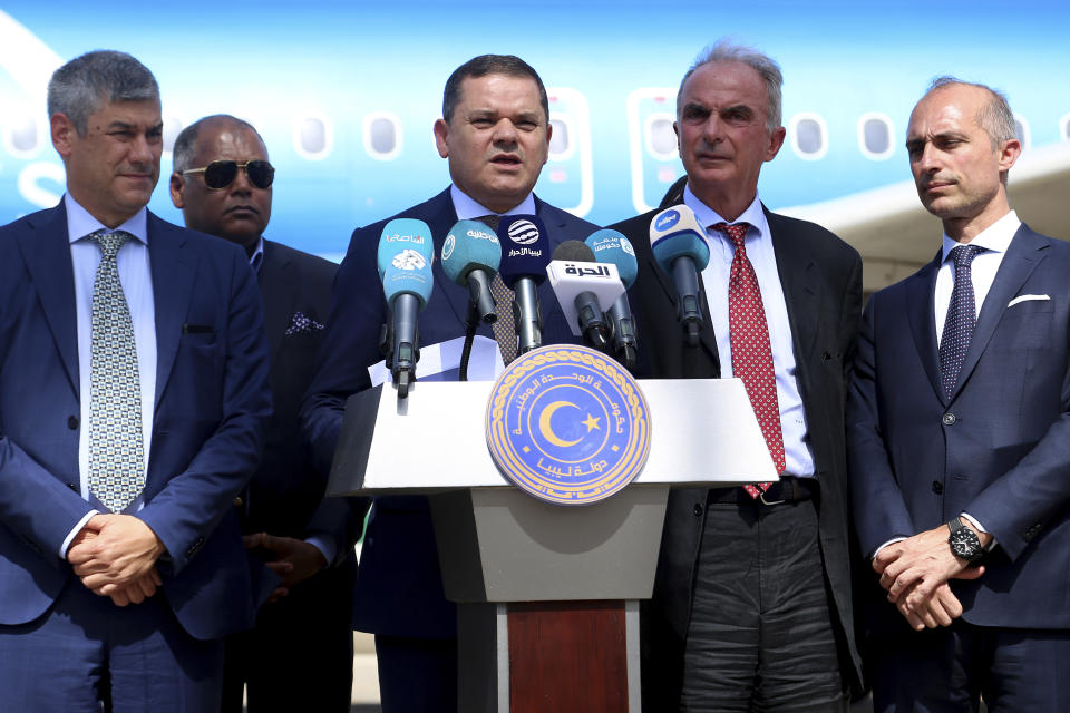 The prime minister of one of Libya's rival administrations, Abdul-Hamid Dbeibah, center, delivers a speech after his arrival in Tripoli, Libya, Monday, July 24, 2023, on the first direct flight between Italy and Libya in nearly a decade by a commercial airline. Oil-rich Libya plunged into chaos after a NATO-backed uprising toppled and killed longtime dictator Moammar Gadhafi in 2011. In the disarray that followed, the country split into rival administrations in the east and west, each backed by rogue militias and foreign governments, and much of the country's international air connections were cancelled. (AP Photo/Yousef Murad)