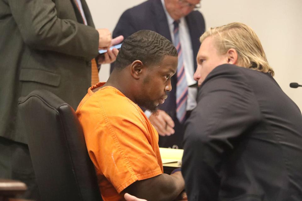 Othal Wallace speaks with his defense team, Friday, July 28, 2023, during a hearing in Judge Raul Zambrano's courtroom at the S. James Foxman Justice Center in Daytona Beach.