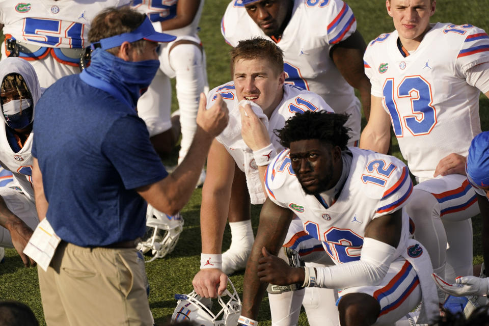 Florida quarterback Kyle Trask (11) listens as head coach Dan Mullen speaks to his players after an NCAA college football game against Vanderbilt Saturday, Nov. 21, 2020, in Nashville, Tenn. Florida won 38-17. (AP Photo/Mark Humphrey)