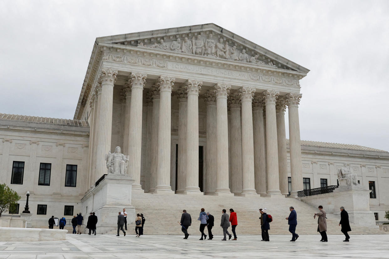 People walk across the plaza of the U.S. Supreme Court building on the first day of the court's new term in Washington, U.S. October 3, 2022.  REUTERS/Jonathan Ernst