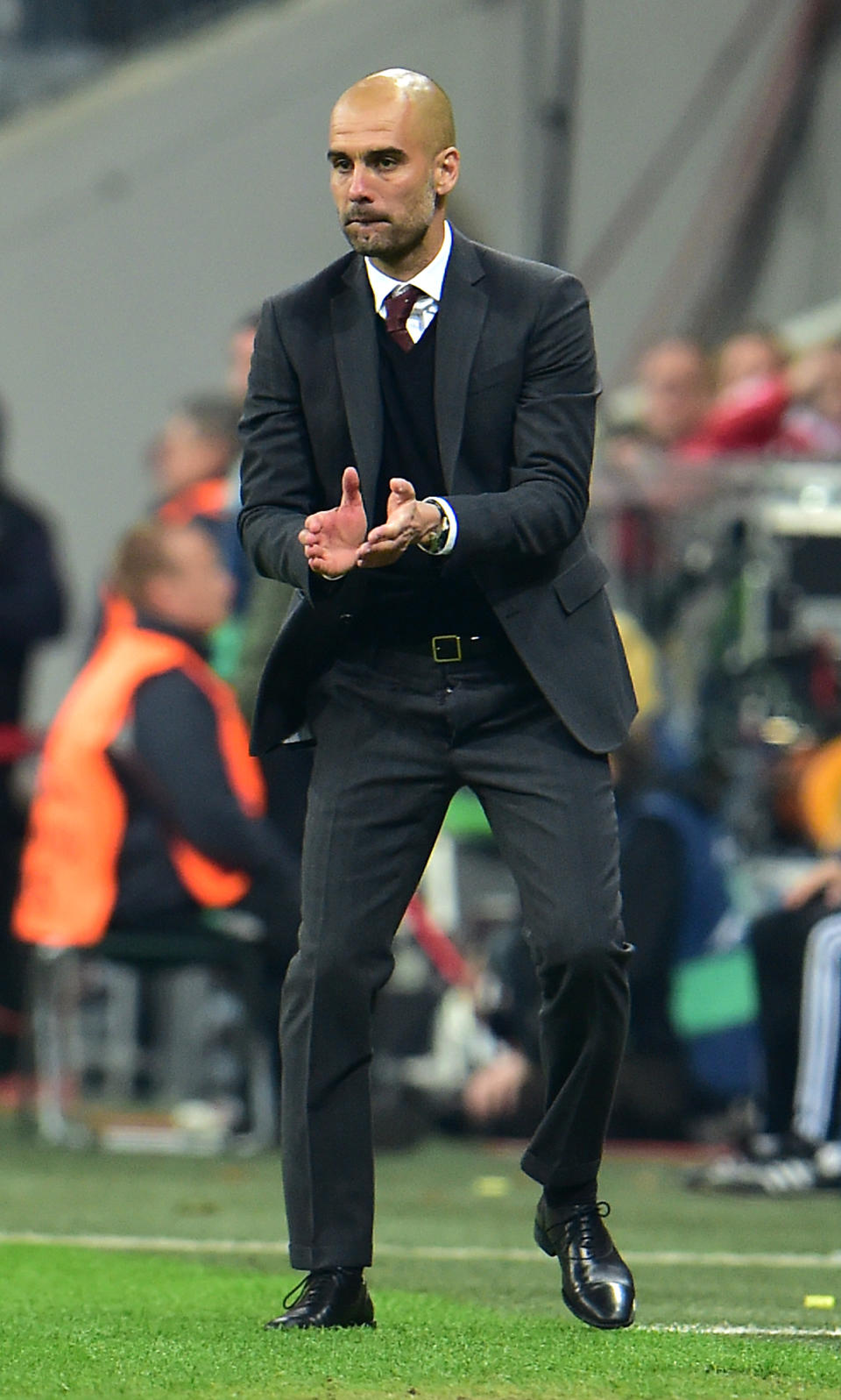 Bayern head coach Pep Guardiola of Spain applauds during the Champions League quarterfinal second leg soccer match between Bayern Munich and Manchester United in the Allianz Arena in Munich, Germany, Wednesday, April 9, 2014. Munich defeated Manchester by 3:1. (AP Photo/Kerstin Joensson)